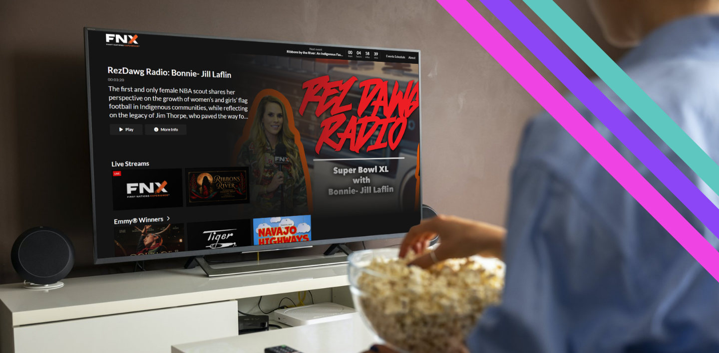 A viewer watching the FNX streaming app on a living-room TV, with RezDawg Radio, live streams, and Emmy-winning programs on screen